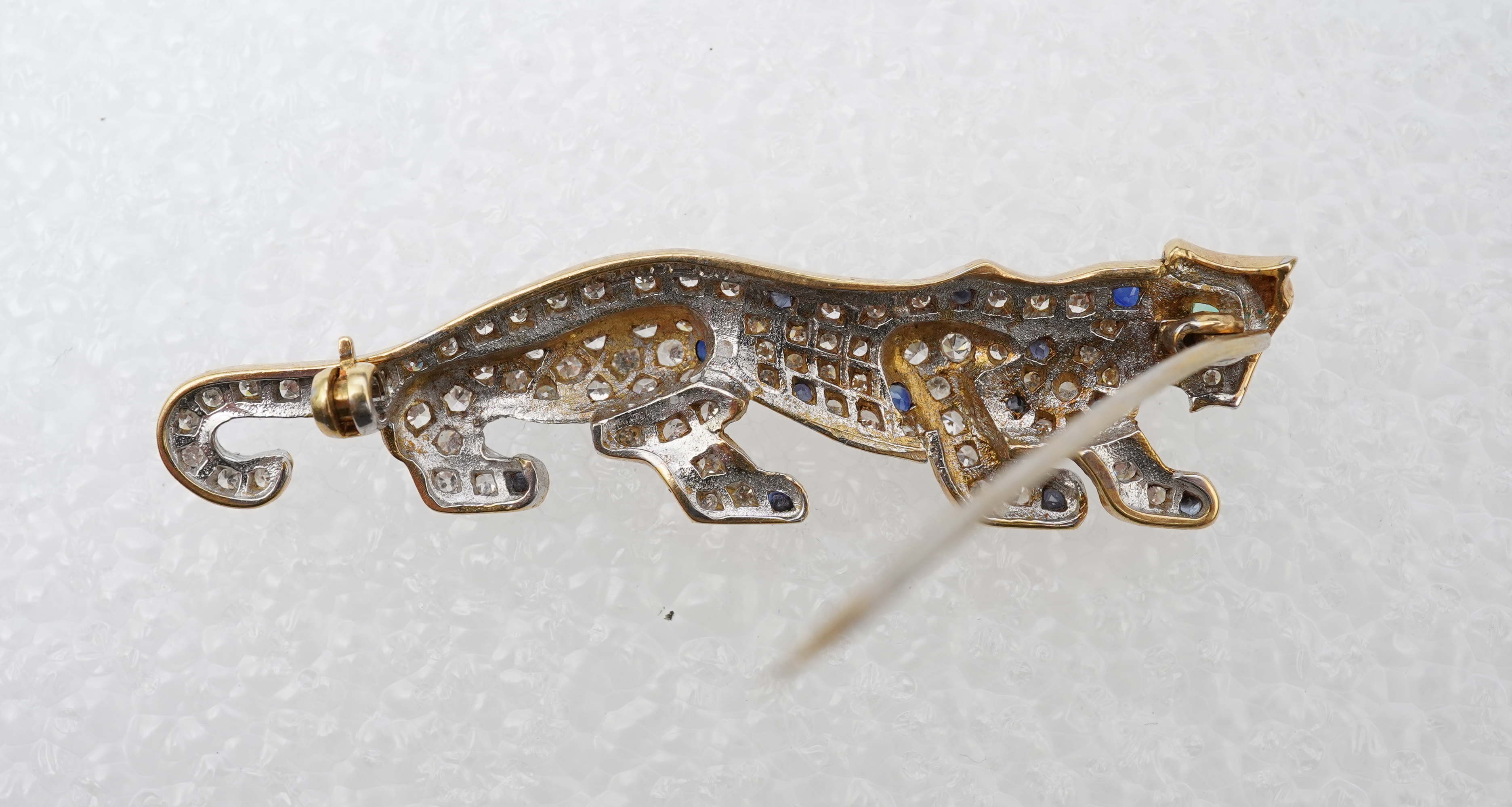 A sapphire, emerald and diamond brooch, circa 1988